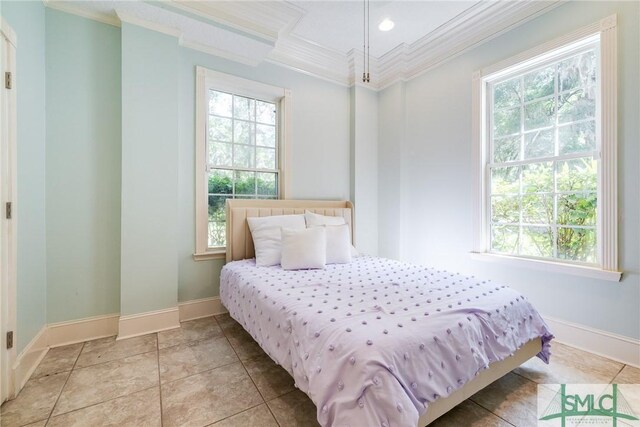 bedroom featuring crown molding and baseboards