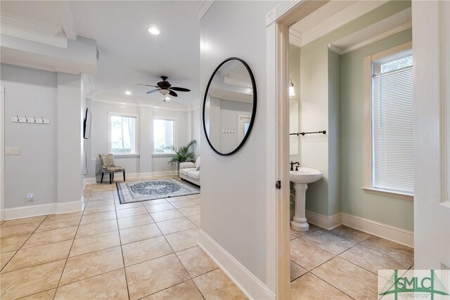 interior space with a ceiling fan, recessed lighting, light tile patterned floors, and crown molding