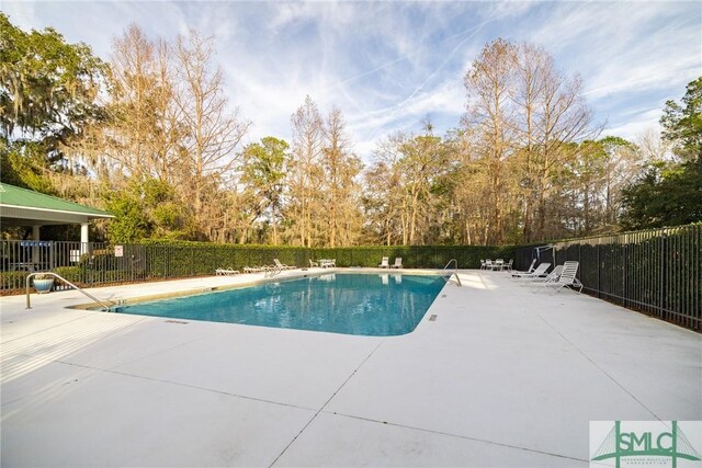 community pool featuring a patio and fence