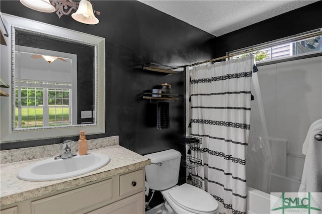 full bathroom featuring shower / bath combination with curtain, toilet, vanity, and a textured ceiling