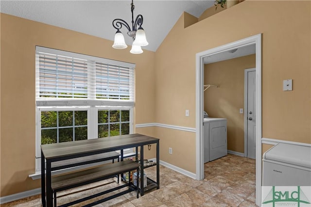dining room with washing machine and dryer, vaulted ceiling, baseboards, and an inviting chandelier