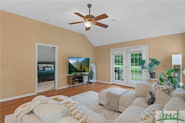 living room with vaulted ceiling, wood finished floors, baseboards, and ceiling fan