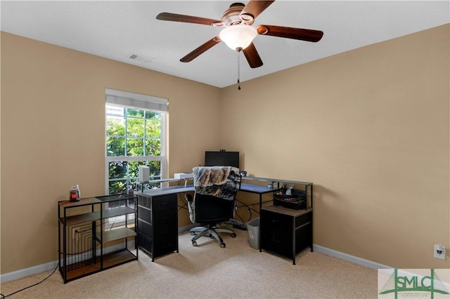carpeted office featuring visible vents, baseboards, and ceiling fan