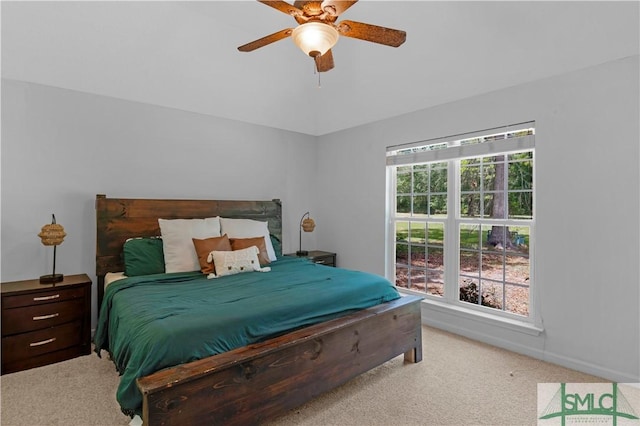 bedroom featuring ceiling fan, light carpet, and baseboards