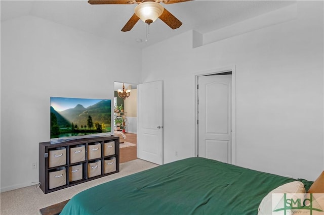 bedroom featuring a high ceiling, light colored carpet, and ceiling fan with notable chandelier