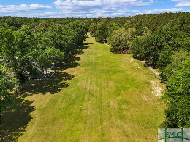 drone / aerial view featuring a wooded view