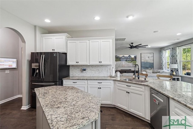 kitchen with a sink, dishwasher, white cabinetry, dark wood-style floors, and a ceiling fan