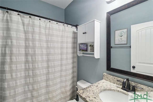 bathroom featuring toilet and vanity