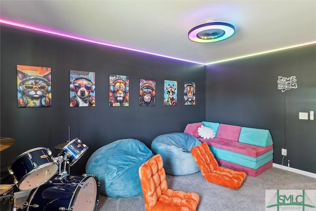 recreation room with baseboards and carpet floors