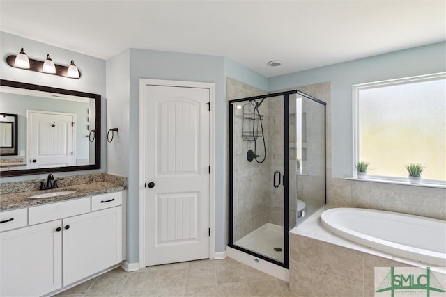 bathroom featuring vanity, a shower stall, a bath, and tile patterned floors