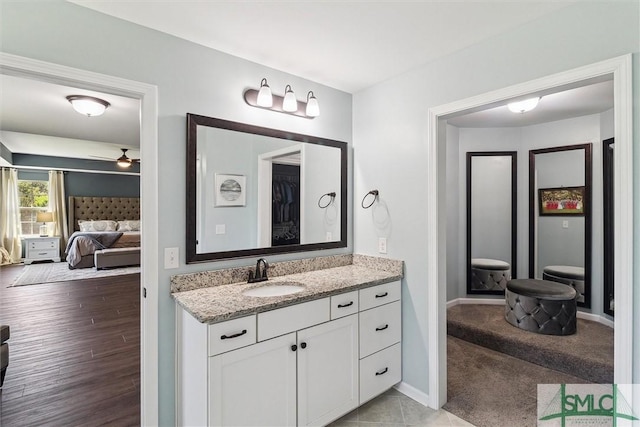 ensuite bathroom with baseboards, ensuite bathroom, and vanity