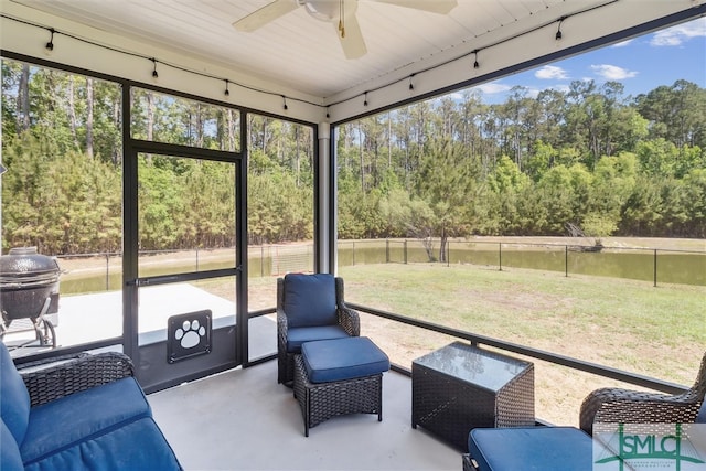 sunroom / solarium with a ceiling fan and outdoor lounge area