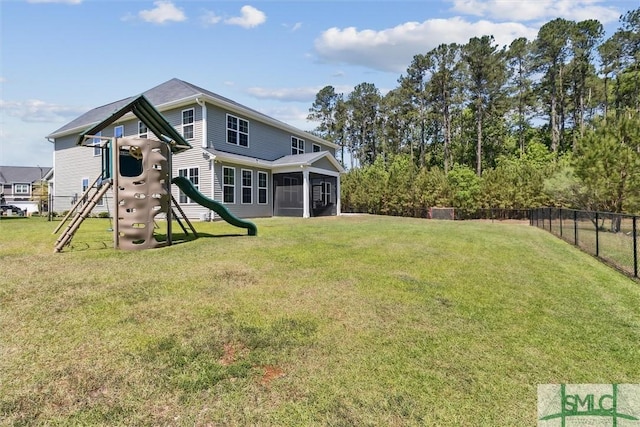 exterior space featuring a sunroom, a playground, and fence