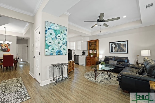 856 E 35th St, Savannah, GA 31401 - living area featuring crown molding, visible vents, wood finished floors, and ceiling fan with notable chandelier