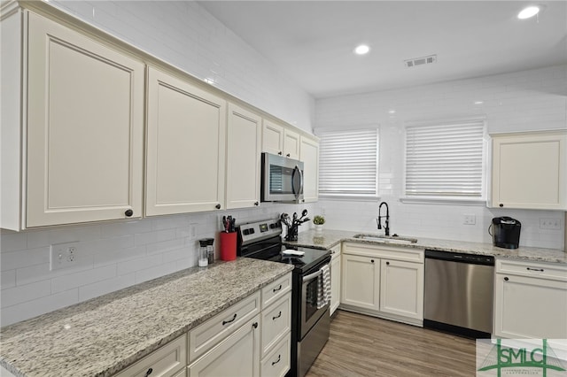 856 E 35th St, Savannah, GA 31401 - kitchen featuring stainless steel appliances, visible vents, a sink, and decorative backsplash
