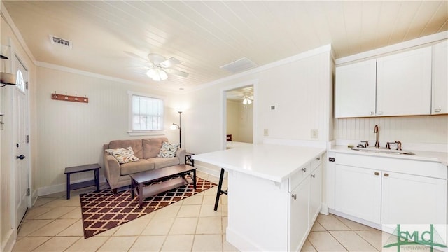 856 E 35th St, Savannah, GA 31401 - kitchen featuring a sink, a peninsula, ornamental molding, visible vents, and a ceiling fan
