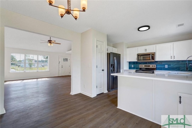4 Tantallon Ct, Pooler, GA 31322 - kitchen with dark wood finished floors, visible vents, white cabinetry, stainless steel appliances, and tasteful backsplash