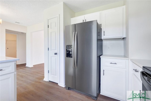4 Tantallon Ct, Pooler, GA 31322 - kitchen with white cabinetry, stainless steel fridge with ice dispenser, light countertops, and visible vents