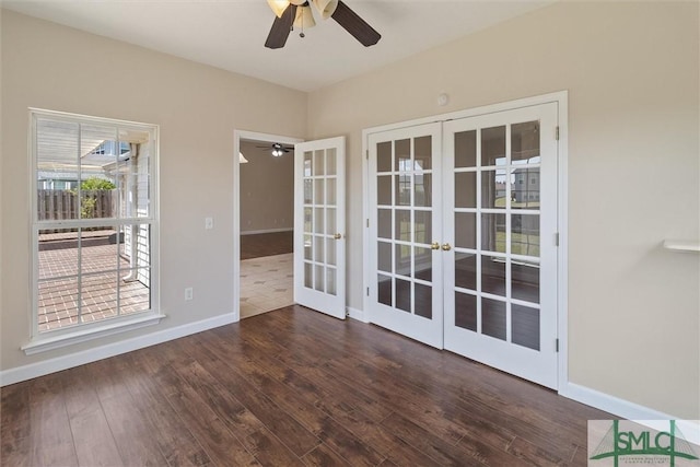 empty room featuring wood finished floors, baseboards, french doors, and a ceiling fan