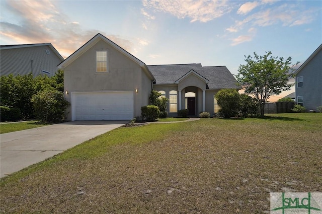 ranch-style house with concrete driveway, stucco siding, a garage, and a yard