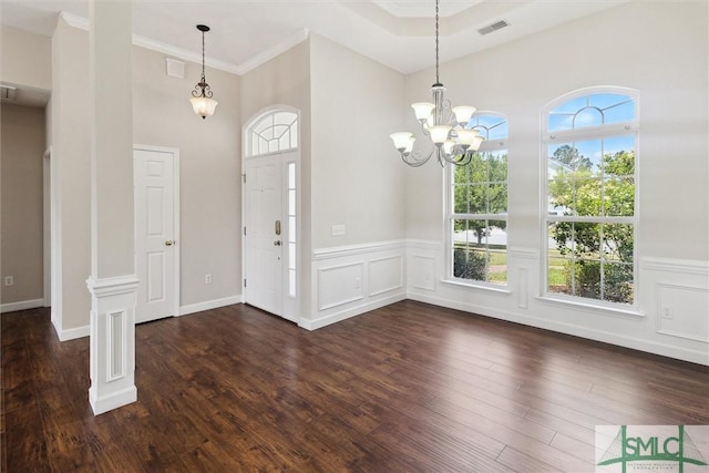 entryway featuring a wainscoted wall, dark wood finished floors, visible vents, and a notable chandelier