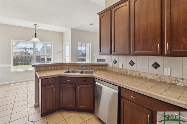 kitchen with a sink, a peninsula, tasteful backsplash, visible vents, and dishwasher