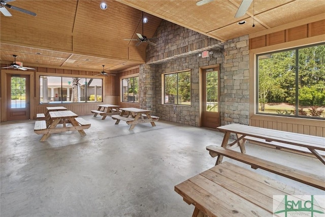 rec room featuring high vaulted ceiling, wooden ceiling, a ceiling fan, plenty of natural light, and concrete floors