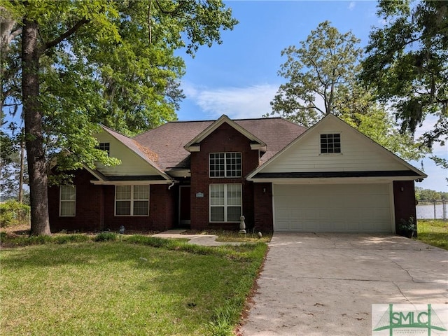 view of front of house featuring a front yard, a garage, brick siding, and driveway