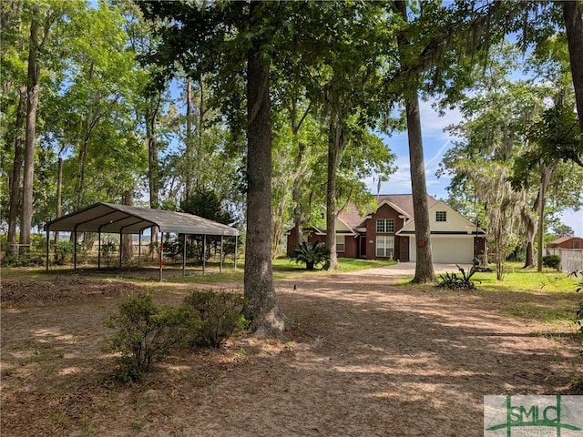 view of property's community with driveway and a carport