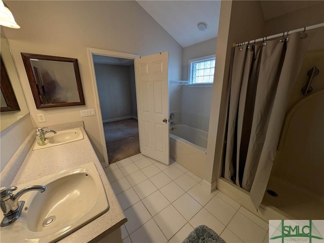 bathroom with tile patterned floors, curtained shower, lofted ceiling, and a sink