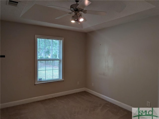 empty room featuring visible vents, baseboards, a ceiling fan, and light carpet
