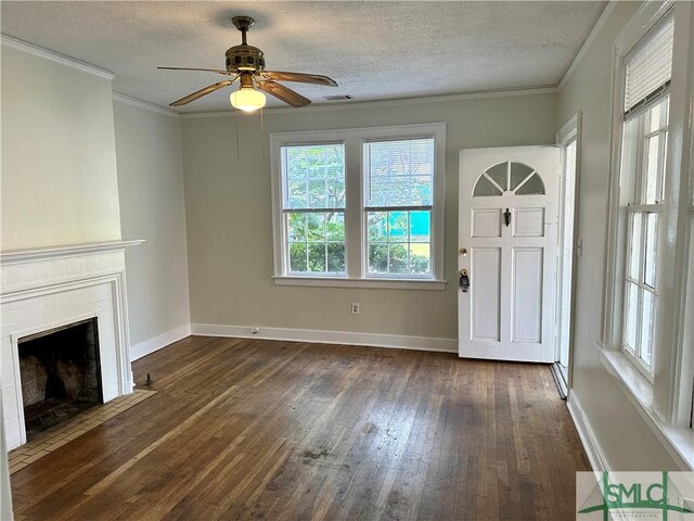 1020 Maupas Ave, Savannah, GA 31401 - unfurnished living room with dark wood-style floors, a ceiling fan, baseboards, a fireplace with flush hearth, and a textured ceiling