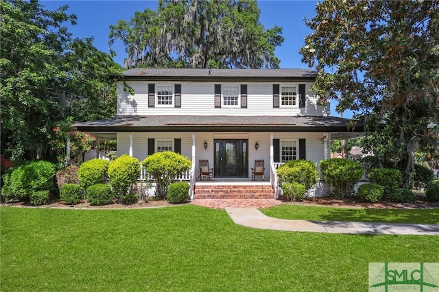view of front facade with covered porch and a front lawn