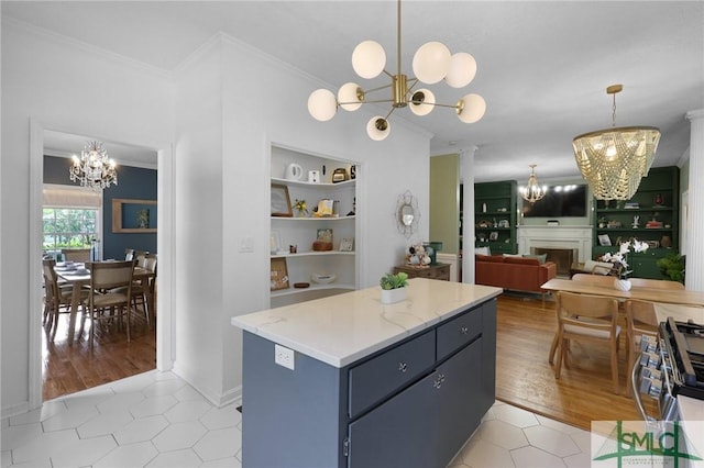 kitchen featuring a chandelier, crown molding, built in shelves, and light tile patterned flooring
