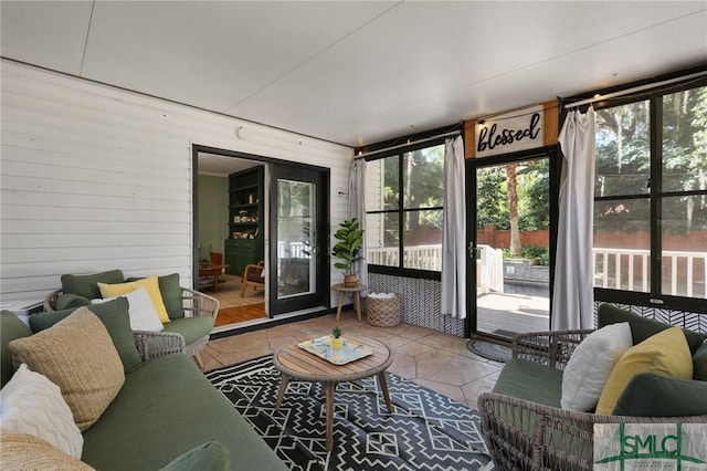 sunroom / solarium featuring outdoor lounge area and healthy amount of natural light