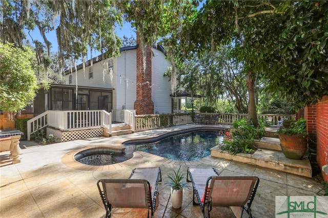 view of pool featuring a sunroom, a patio area, and a fenced backyard