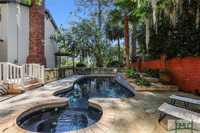 view of swimming pool featuring a fenced backyard and a patio area