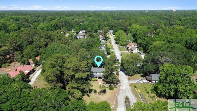 view of property location with a heavily wooded area