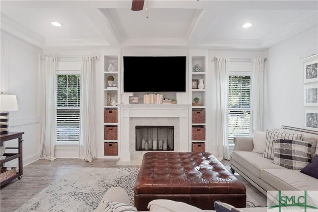 195 Wildlife View Ct N, Richmond Hill, GA 31324 - living area with plenty of natural light, coffered ceiling, a high end fireplace, a ceiling fan, and beam ceiling