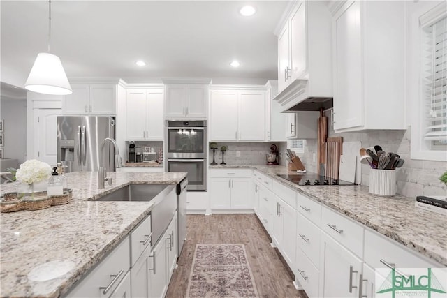 195 Wildlife View Ct N, Richmond Hill, GA 31324 - kitchen with stainless steel appliances, light wood-type flooring, white cabinetry, and recessed lighting