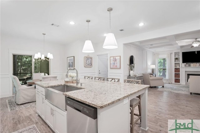 195 Wildlife View Ct N, Richmond Hill, GA 31324 - kitchen with stainless steel dishwasher, a sink, a decorative wall, open floor plan, and recessed lighting