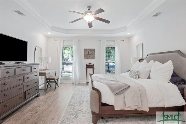 195 Wildlife View Ct N, Richmond Hill, GA 31324 - bedroom with a tray ceiling, light wood finished floors, crown molding, and a ceiling fan