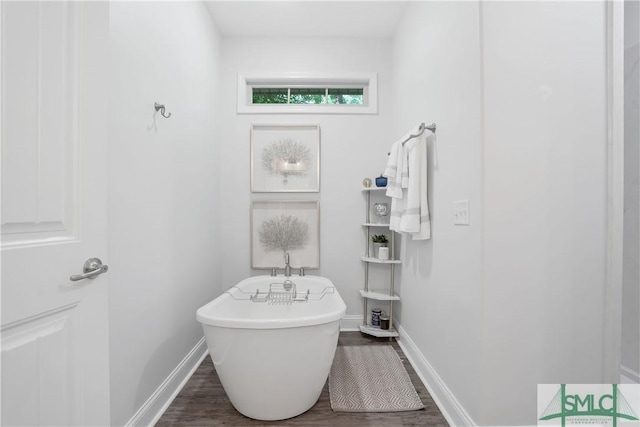 195 Wildlife View Ct N, Richmond Hill, GA 31324 - bathroom featuring wood finished floors, a freestanding tub, and baseboards