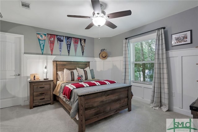195 Wildlife View Ct N, Richmond Hill, GA 31324 - carpeted bedroom with wainscoting, a decorative wall, and ceiling fan