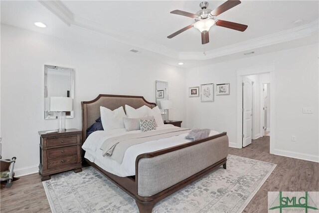 195 Wildlife View Ct N, Richmond Hill, GA 31324 - bedroom with ornamental molding, wood finished floors, a raised ceiling, baseboards, and recessed lighting