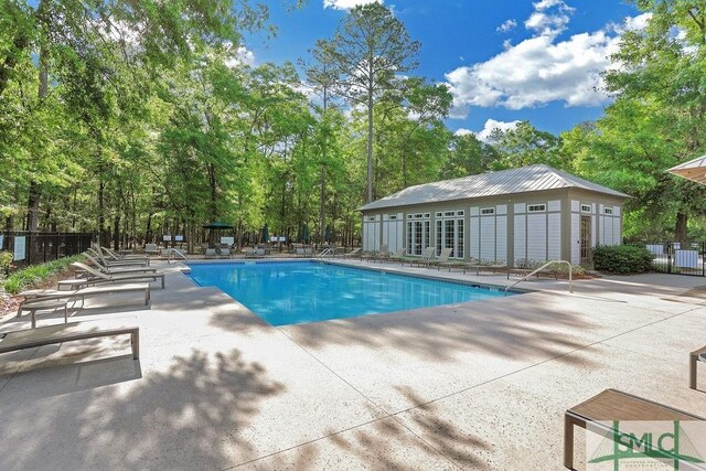 195 Wildlife View Ct N, Richmond Hill, GA 31324 - community pool featuring a patio, fence, and an outdoor structure