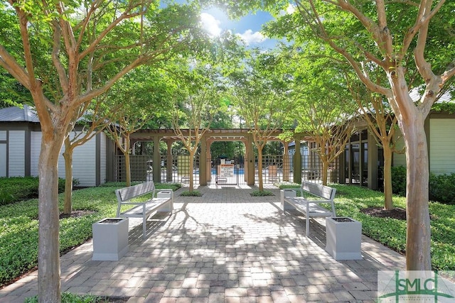 195 Wildlife View Ct N, Richmond Hill, GA 31324 - surrounding community with fence, a pergola, and a patio area