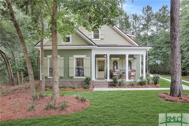 195 Wildlife View Ct N, Richmond Hill, GA 31324 - view of front facade featuring covered porch and a front yard