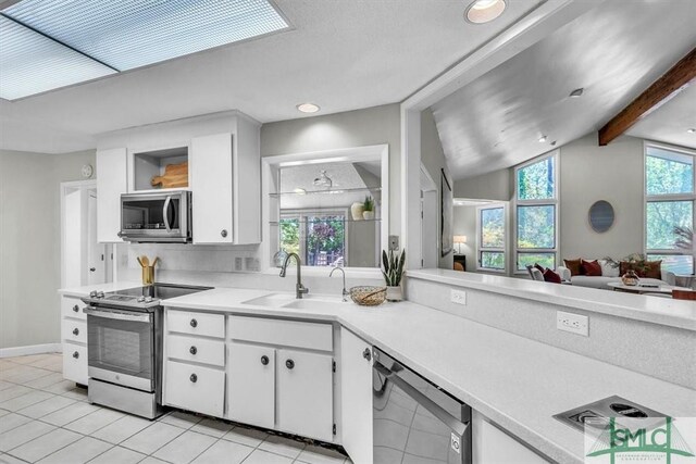 11 Fat Friars Retreat Retreat, Savannah, GA 31411 - kitchen with appliances with stainless steel finishes, open shelves, light tile patterned floors, a sink, and light countertops