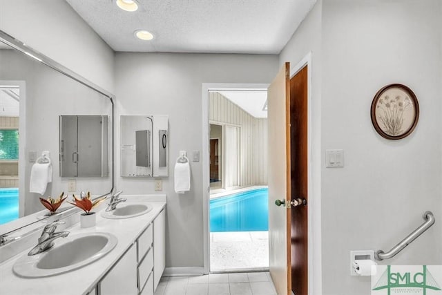11 Fat Friars Retreat Retreat, Savannah, GA 31411 - bathroom featuring tile patterned flooring, baseboards, double vanity, and a textured ceiling